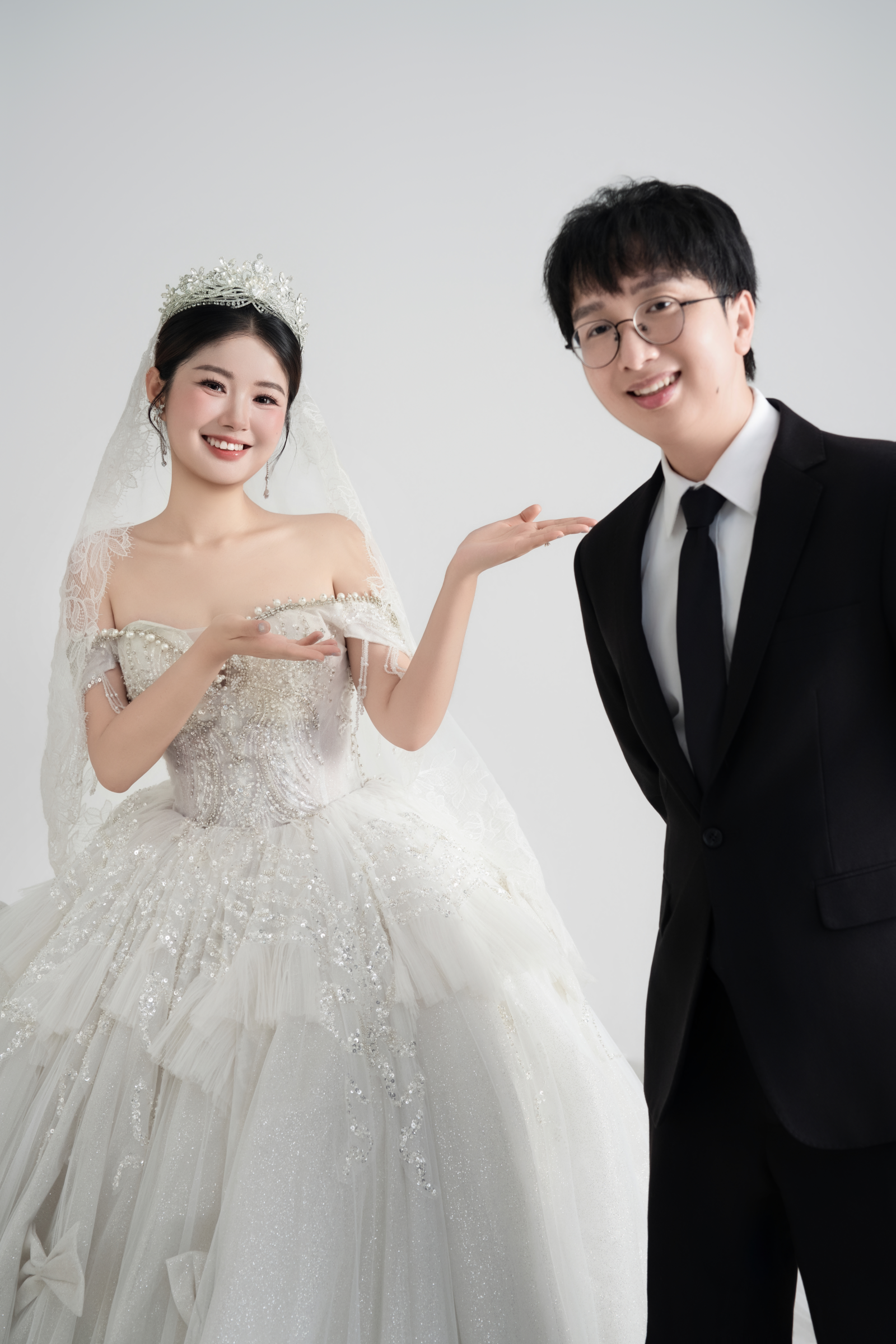 DSC06829 原始婚纱照：新娘抬手介绍新郎，两人微笑看向镜头